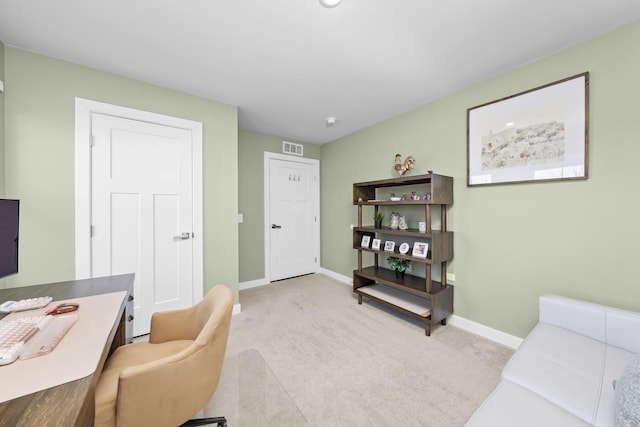 carpeted office space featuring visible vents and baseboards