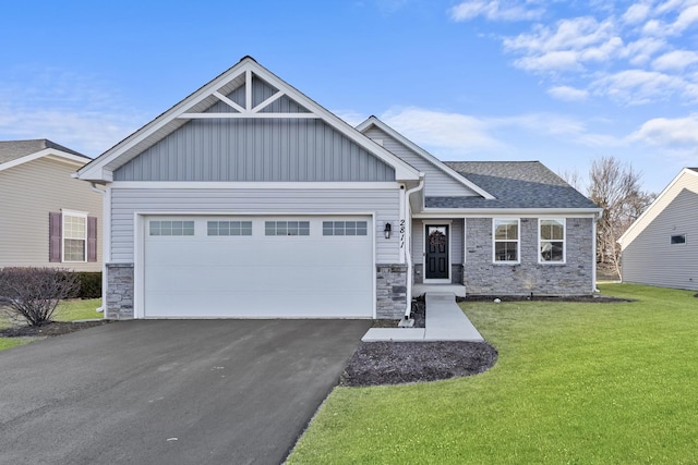 craftsman inspired home featuring stone siding, an attached garage, board and batten siding, and a front lawn