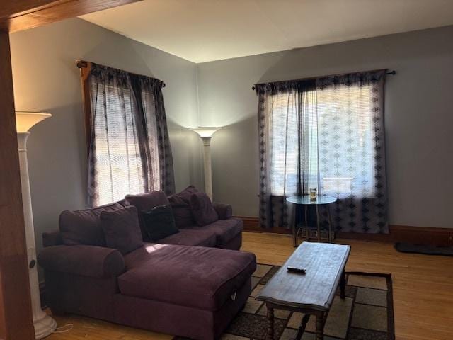 living room featuring baseboards and wood finished floors