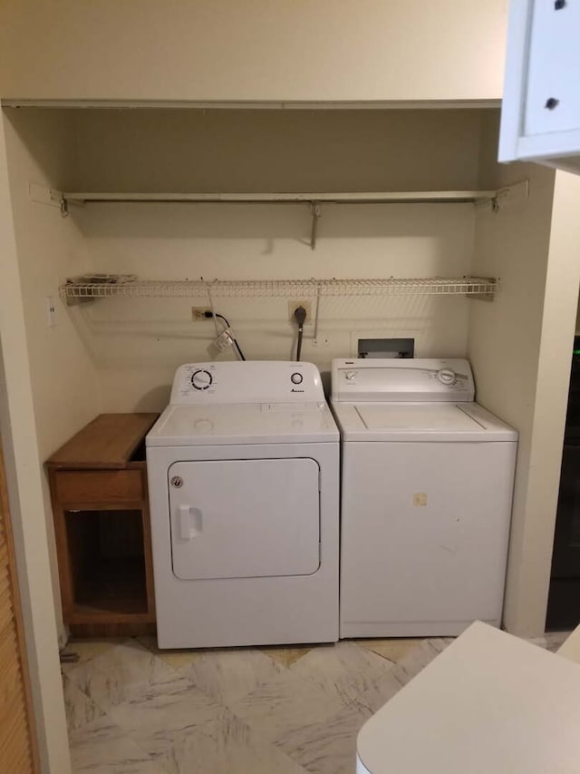 laundry area with laundry area, marble finish floor, and washing machine and clothes dryer