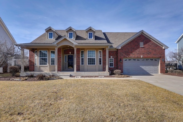 view of front of house featuring brick siding, covered porch, concrete driveway, and a front lawn