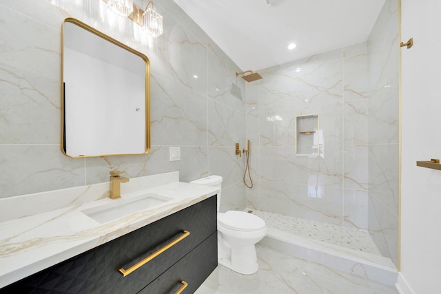 full bathroom with toilet, marble finish floor, a marble finish shower, tile walls, and vanity