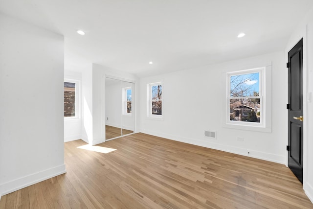 interior space with baseboards, recessed lighting, visible vents, and light wood-type flooring