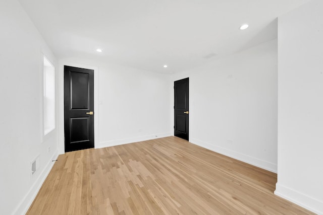 empty room featuring recessed lighting, light wood-style floors, and baseboards