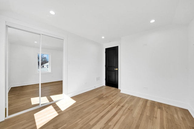 unfurnished bedroom with recessed lighting, baseboards, and light wood-style floors