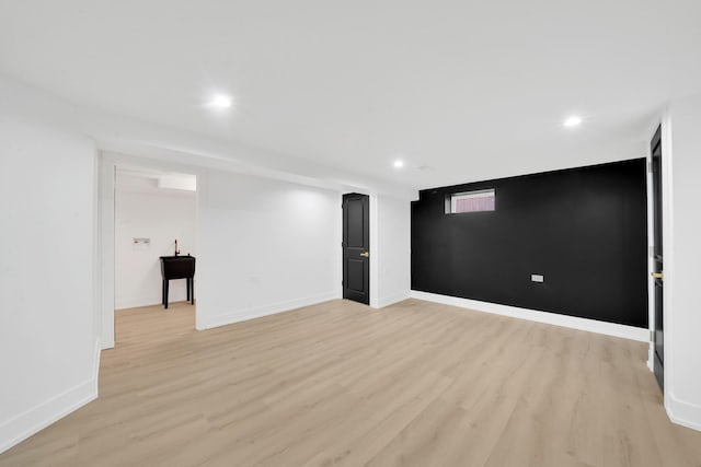 finished basement featuring recessed lighting, baseboards, and light wood finished floors