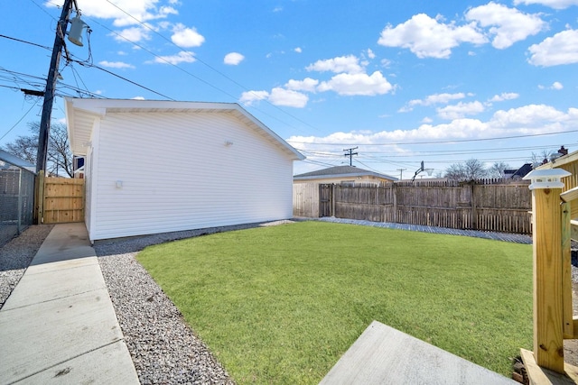 view of yard with an outbuilding and a fenced backyard