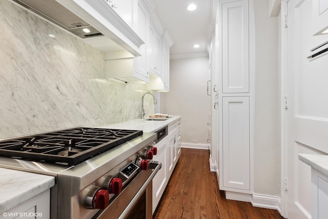 kitchen with premium range hood, a sink, high end range, and white cabinetry