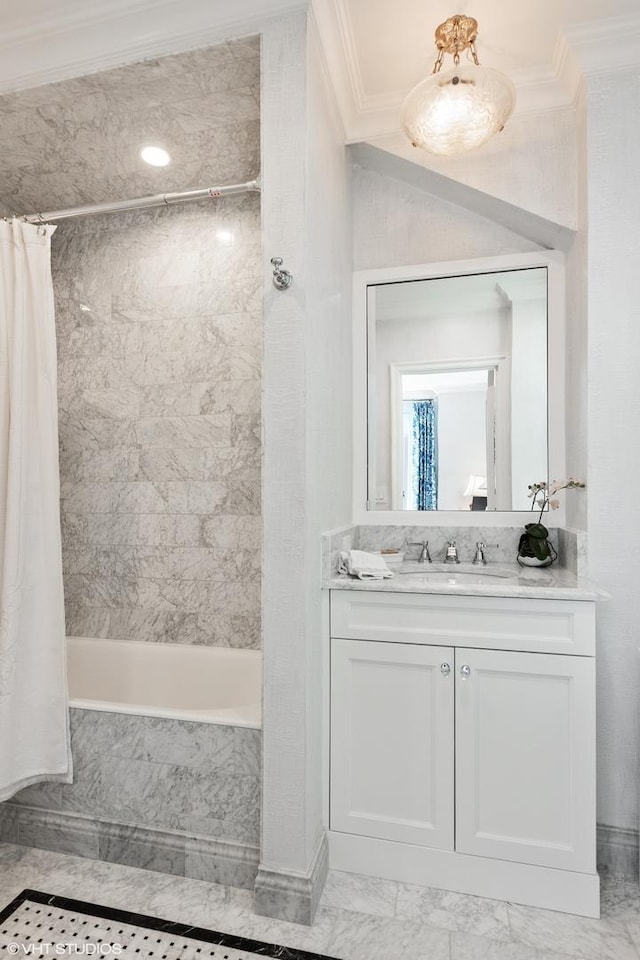 bathroom featuring marble finish floor, a combined bath / shower with marble appearance, ornamental molding, and vanity