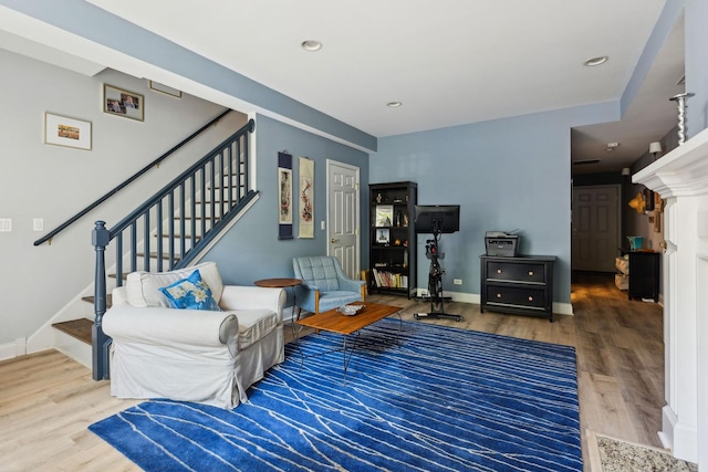 living area with stairs, recessed lighting, wood finished floors, and baseboards