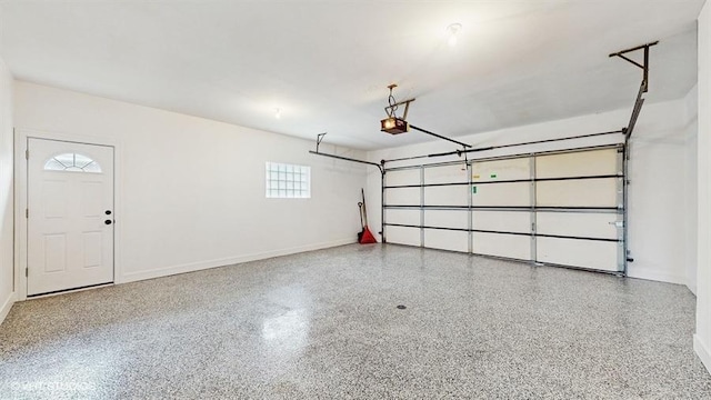 garage with a garage door opener and baseboards