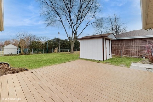 deck featuring an outbuilding, a lawn, and a shed