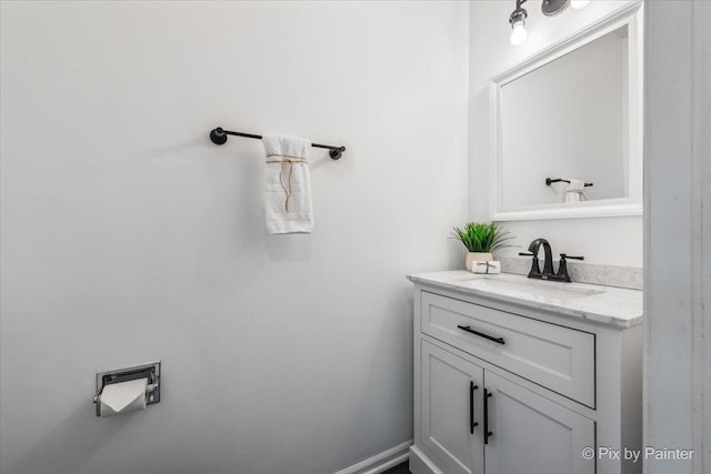 bathroom featuring baseboards and vanity