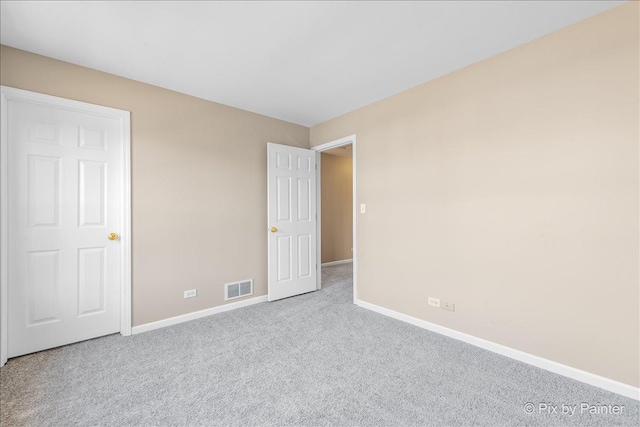 unfurnished bedroom featuring visible vents, baseboards, and carpet flooring