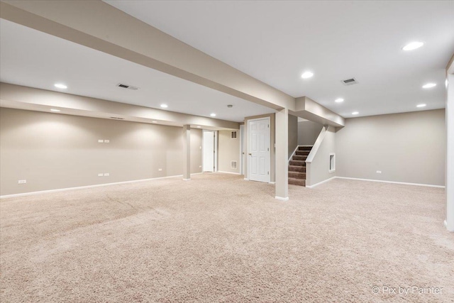 finished basement with recessed lighting, visible vents, light carpet, and stairway