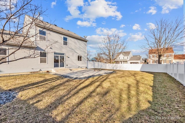 back of house with a patio, a lawn, a fenced backyard, and entry steps