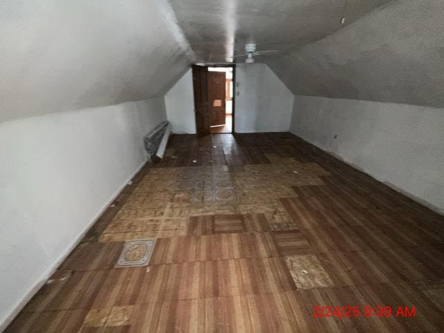 bonus room with lofted ceiling, radiator, and wood finished floors