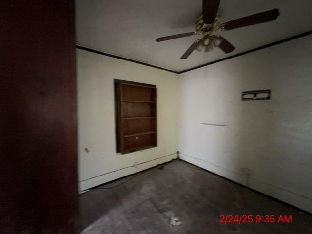 unfurnished room with concrete floors, a ceiling fan, and crown molding