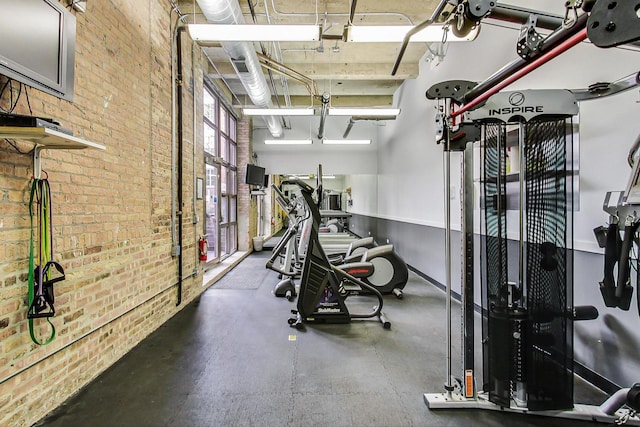 exercise room with brick wall