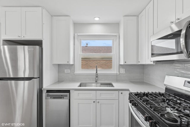 kitchen featuring a sink, white cabinetry, and stainless steel appliances