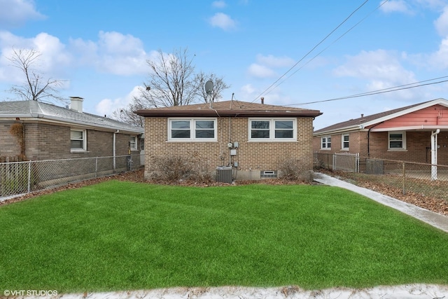 back of property featuring a yard, fence private yard, and brick siding