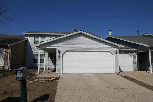 view of front of property featuring concrete driveway and an attached garage