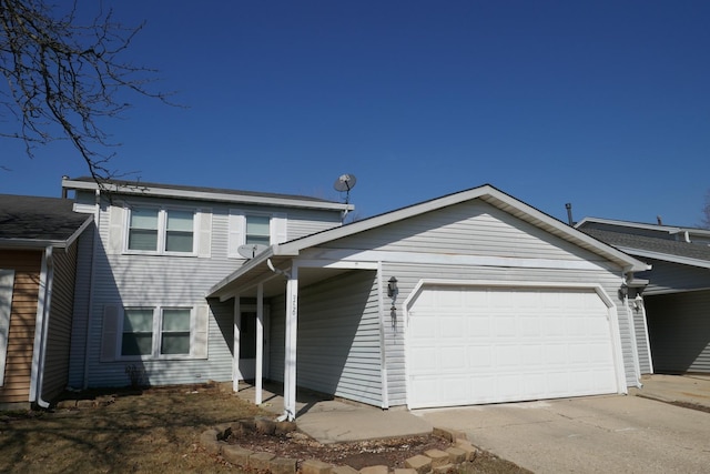 traditional-style house featuring a garage and driveway