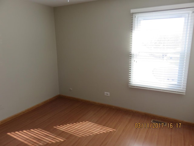 unfurnished room with baseboards