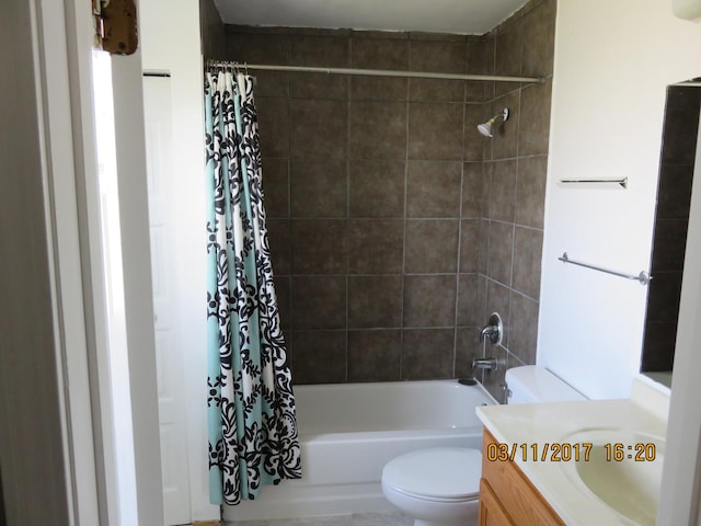 full bath featuring toilet, vanity, and shower / bath combination with curtain