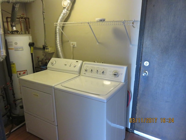 laundry room featuring washer and dryer, laundry area, and water heater