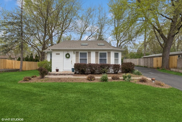 view of front of home with driveway and a shingled roof