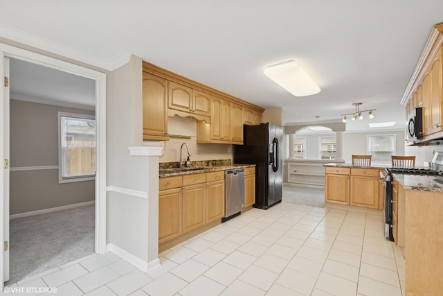kitchen with stainless steel appliances, arched walkways, a peninsula, light colored carpet, and light tile patterned flooring