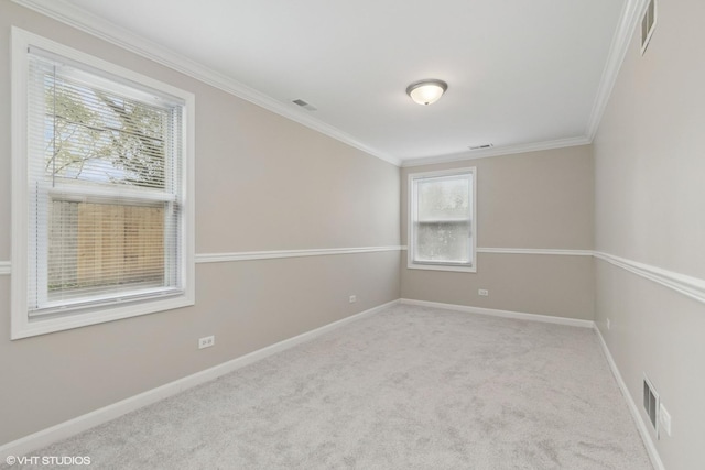 carpeted empty room with ornamental molding and baseboards