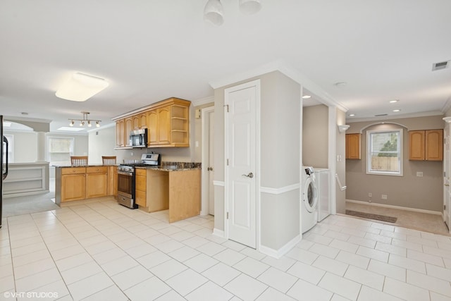 kitchen featuring stainless steel appliances, washing machine and dryer, ornamental molding, a peninsula, and open shelves