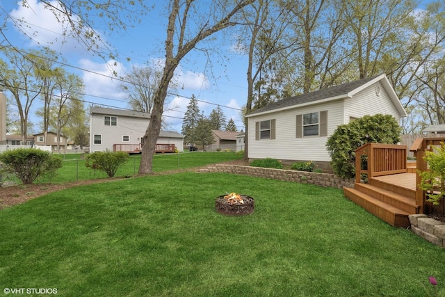 view of yard with a fire pit and a deck