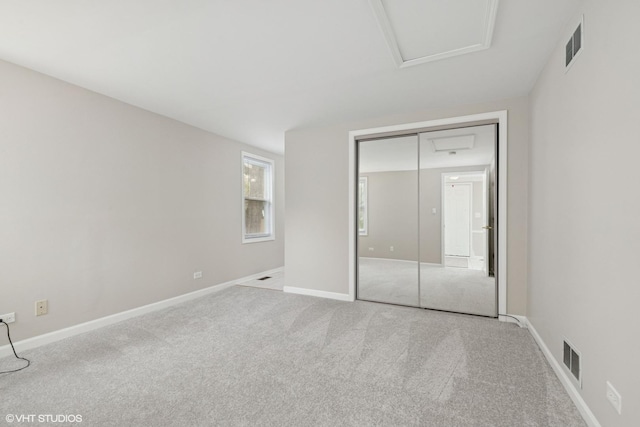 unfurnished bedroom with carpet flooring, a closet, and baseboards
