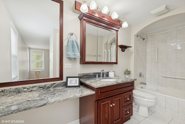 bathroom featuring vanity, tub / shower combination, tile patterned flooring, and toilet