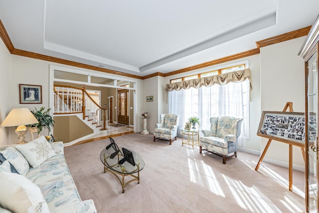 living room featuring carpet flooring, a raised ceiling, stairs, and crown molding