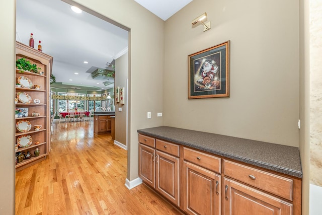 corridor with recessed lighting, baseboards, and light wood-style floors