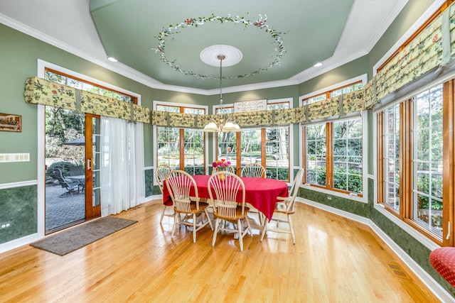 sunroom / solarium with a wealth of natural light, visible vents, and a notable chandelier