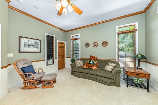 living area with crown molding, carpet, and a healthy amount of sunlight