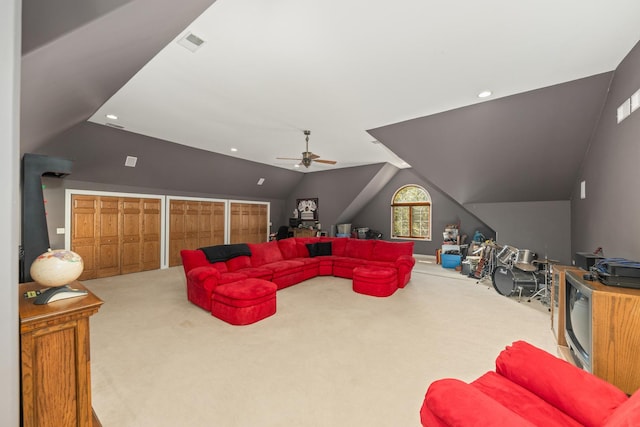 living area featuring visible vents, ceiling fan, carpet, and vaulted ceiling