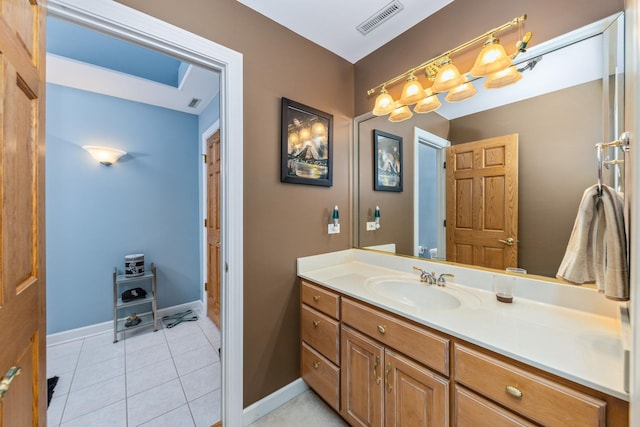 bathroom with tile patterned floors, visible vents, baseboards, and vanity