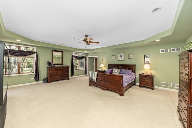 bedroom with visible vents, light carpet, and baseboards