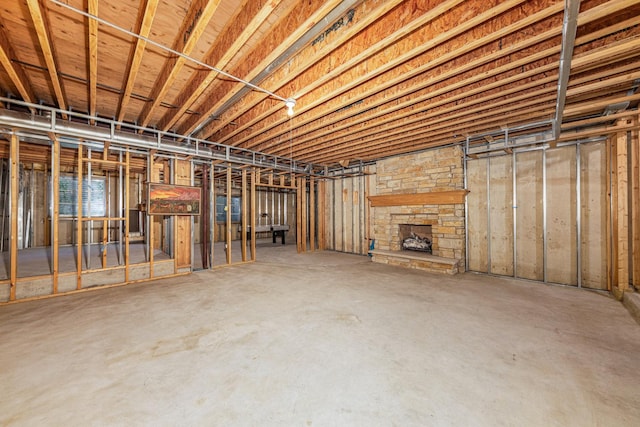 unfinished basement with a fireplace