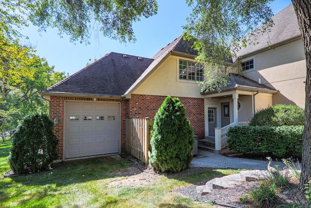 traditional-style house featuring brick siding, roof with shingles, stucco siding, a garage, and driveway