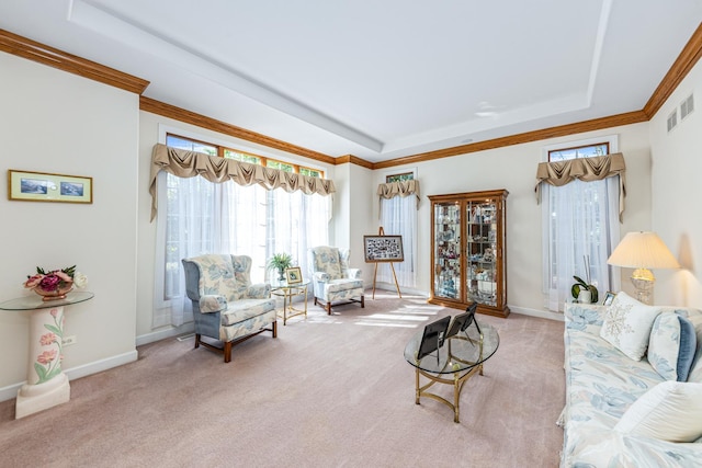 carpeted living room with a tray ceiling, baseboards, visible vents, and ornamental molding