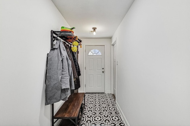 doorway to outside with baseboards