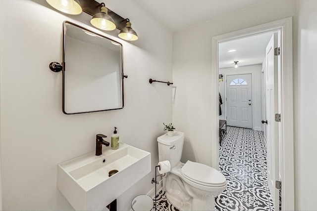 bathroom with toilet and a sink