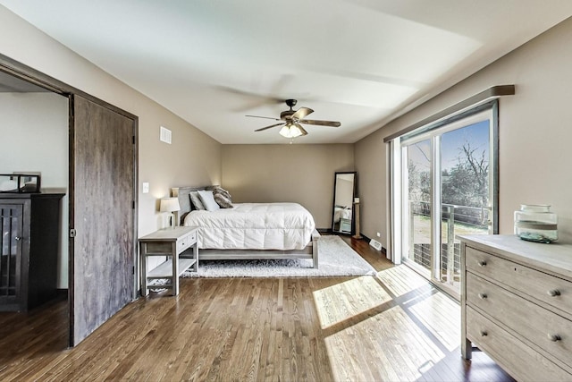 bedroom featuring access to exterior, wood finished floors, and ceiling fan